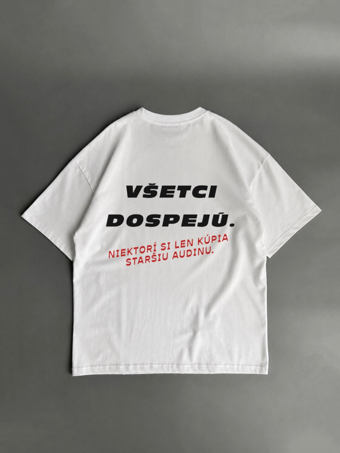 Všetci dospejú – niektorí si len kúpia staršie Audi – biele oversized tričko s potlačou